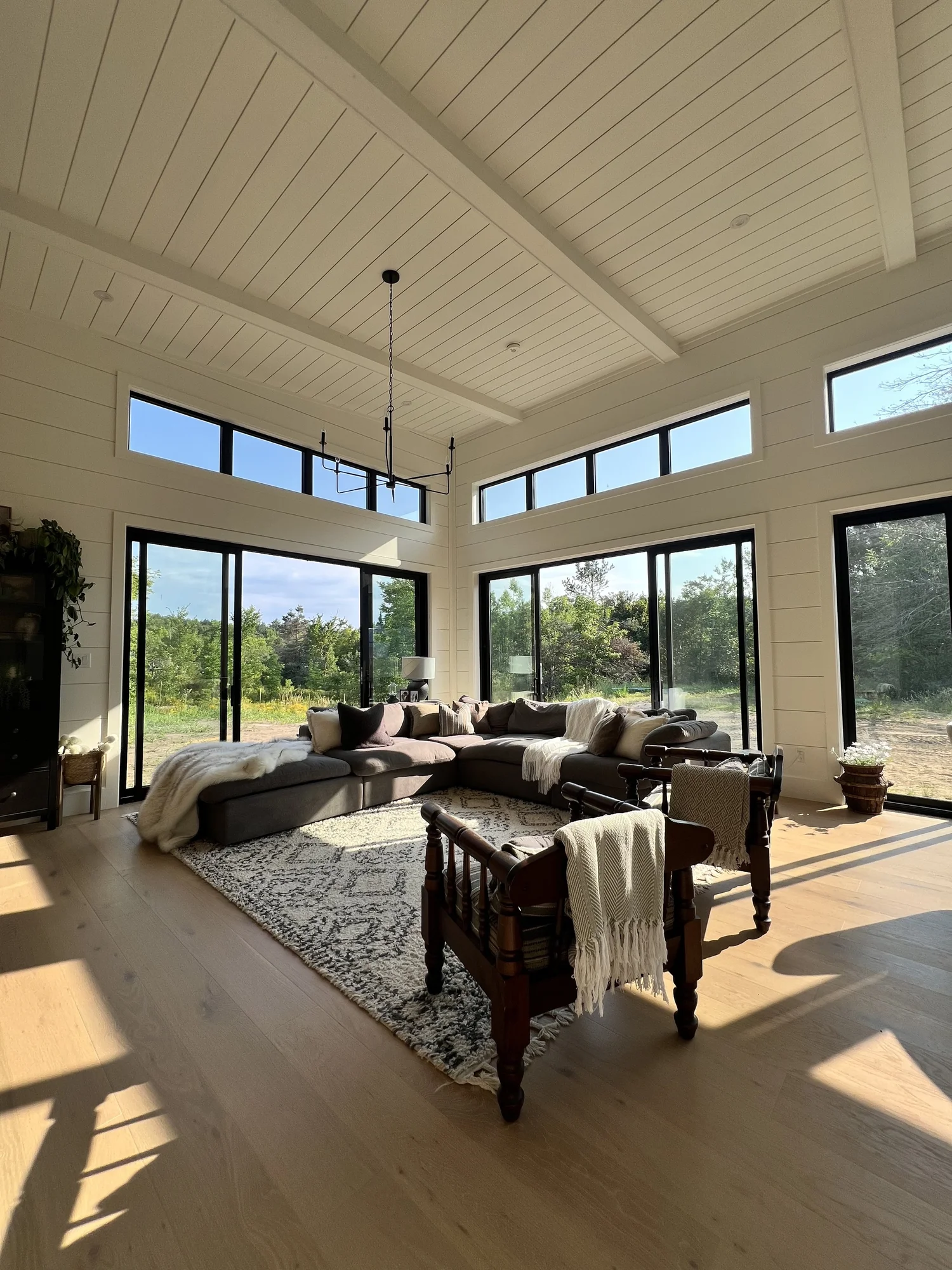 Bright cottage living room with vaulted ceilings and lake views
